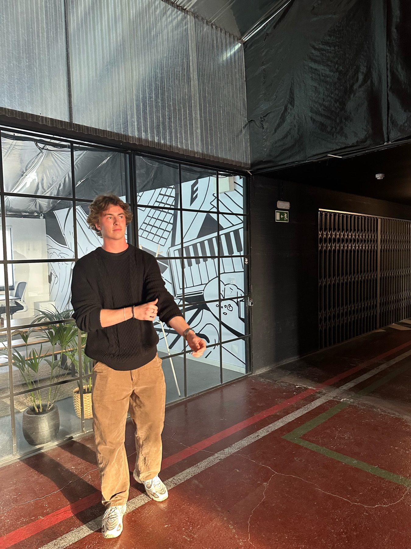 Jack standing in a sunlit creative workspace in Lisbon